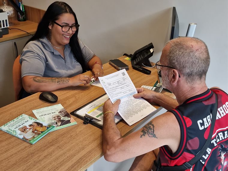 Consultora da F3 Assistencial explicando o plano a um cliente